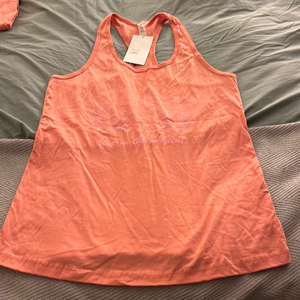“Live in the moment” racer tank. Nice flowing fit around the bottom, NWT size M
